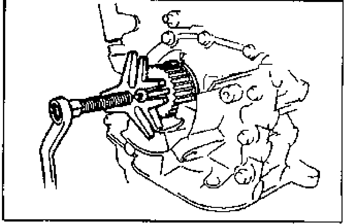 Drawing showing removal of the timing belt pulley with a steering wheel puller engaged on the crankshaft end.