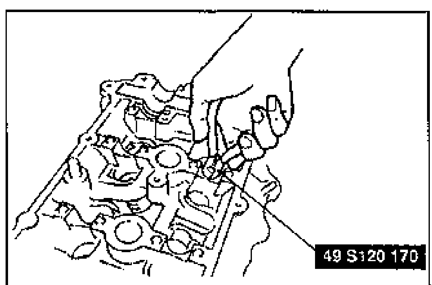Drawing of a hand using the SST (49 S120 170) to grip and pull a valve seal off the valve guide on the cylinder head.