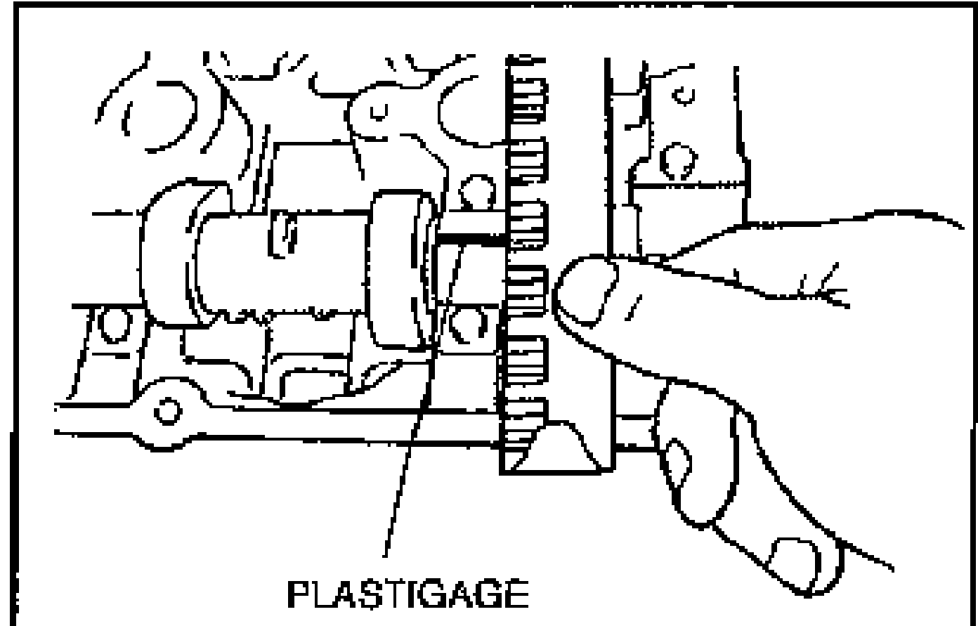 Illustration of measuring camshaft end play with a dial indicator mounted on the cylinder head against the camshaft gear; arrow shows axial movement.
