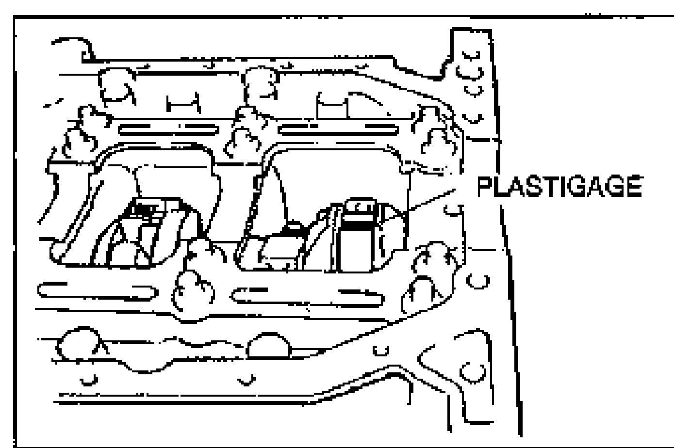 Line drawing of the crankshaft journal area with Plastigage placed atop the journal in the axial direction. PLASTIGAGE callout points to the strip.