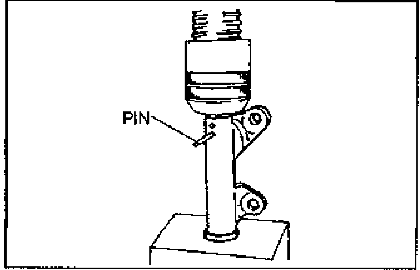 Auto tensioner with a PIN inserted into the second hole in the body to hold the tensioner rod compressed.