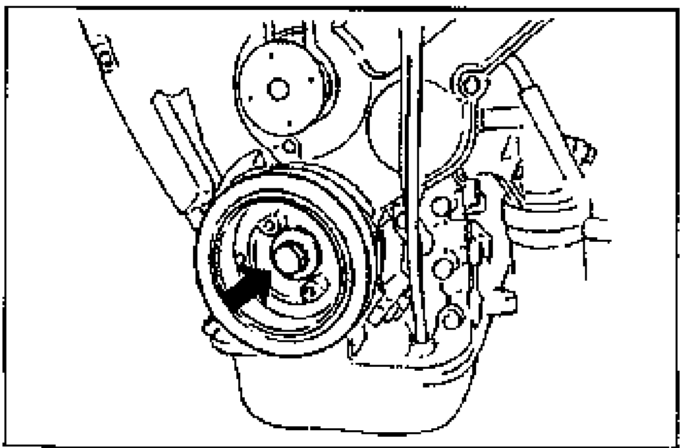 Front view of the engine showing the crankshaft pulley installation with an arrow pointing to the crankshaft pulley bolt at the lower front of the engine.