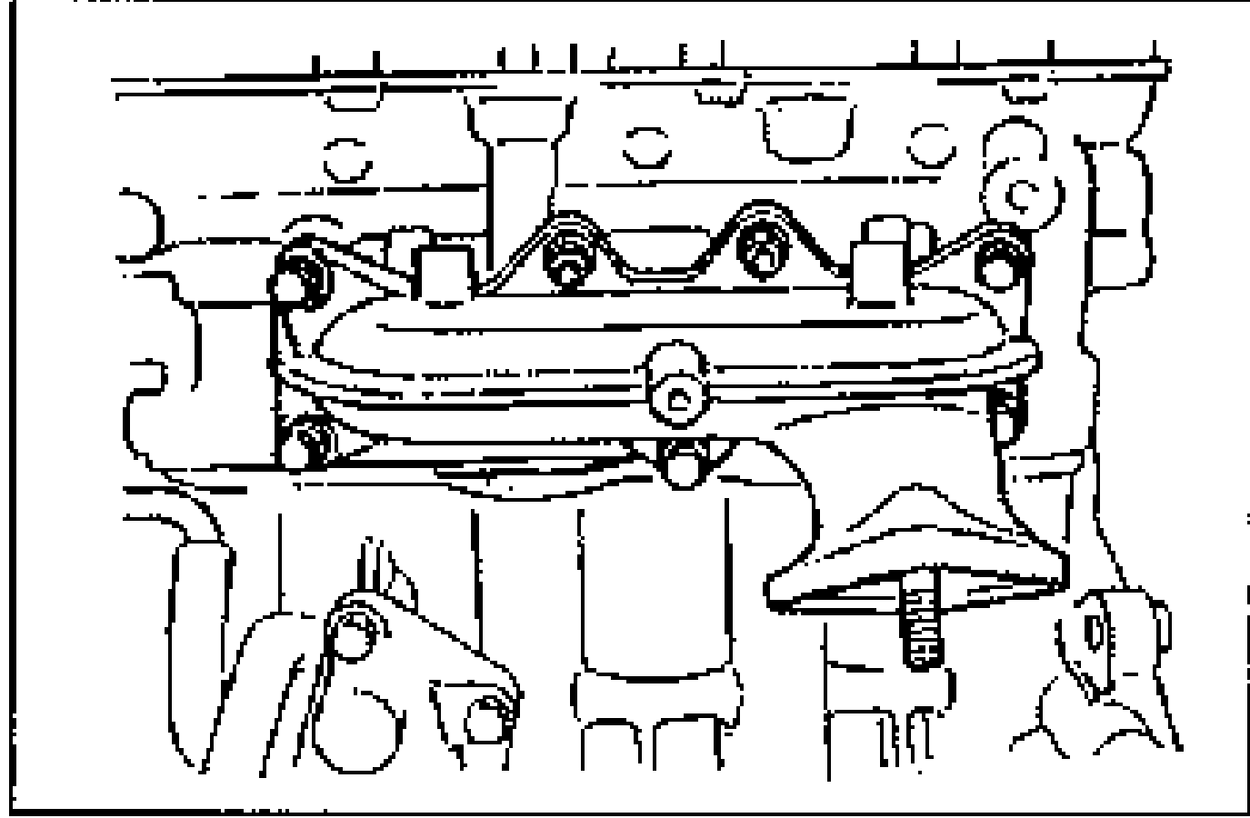 Left (LH) exhaust manifold installed on the cylinder head, showing the manifold and its mounting bolts with a new gasket in position.