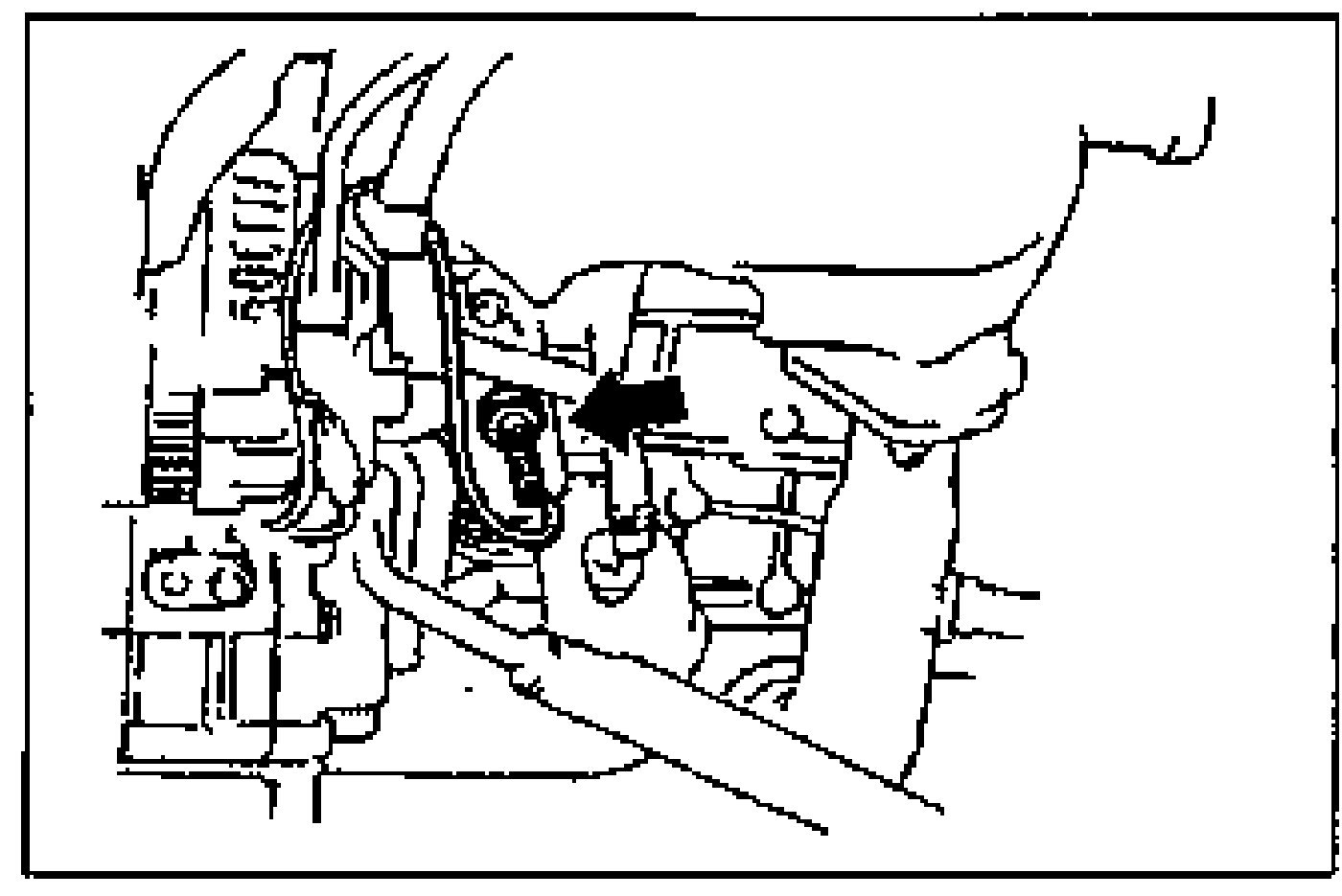 Engine-bay photo with an arrow pointing to the oil pressure switch location. Illustrates removing the oil pressure switch.