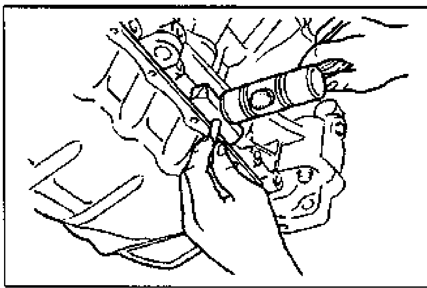 Illustration of inserting a screwdriver/tool into the gap between the cylinder block and oil pan to pry the pan free. Illustrates separating the oil pan.