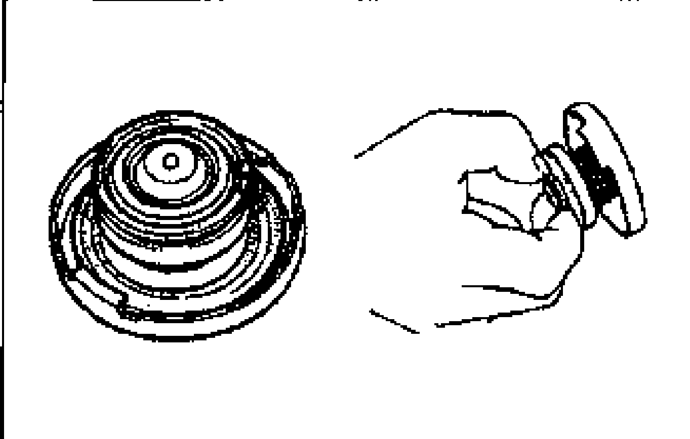 Hand pulling open the negative pressure valve on the underside of the radiator cap to check that it closes completely when released.