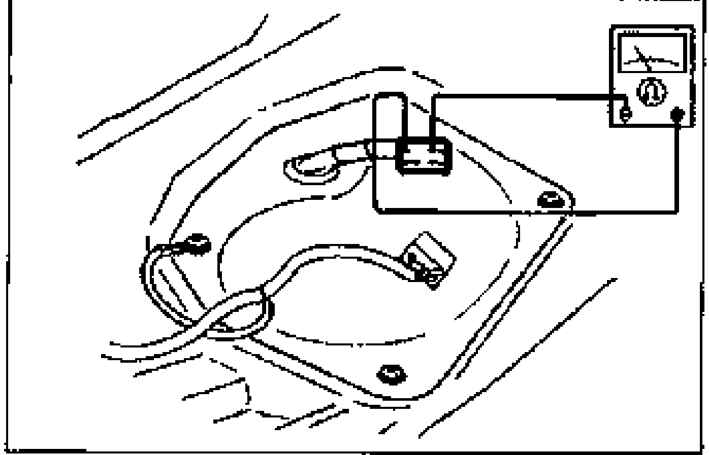 Under-seat view of the fuel pump connector with an ohmmeter/circuit tester connected to check continuity between the fuel pump connector terminals.