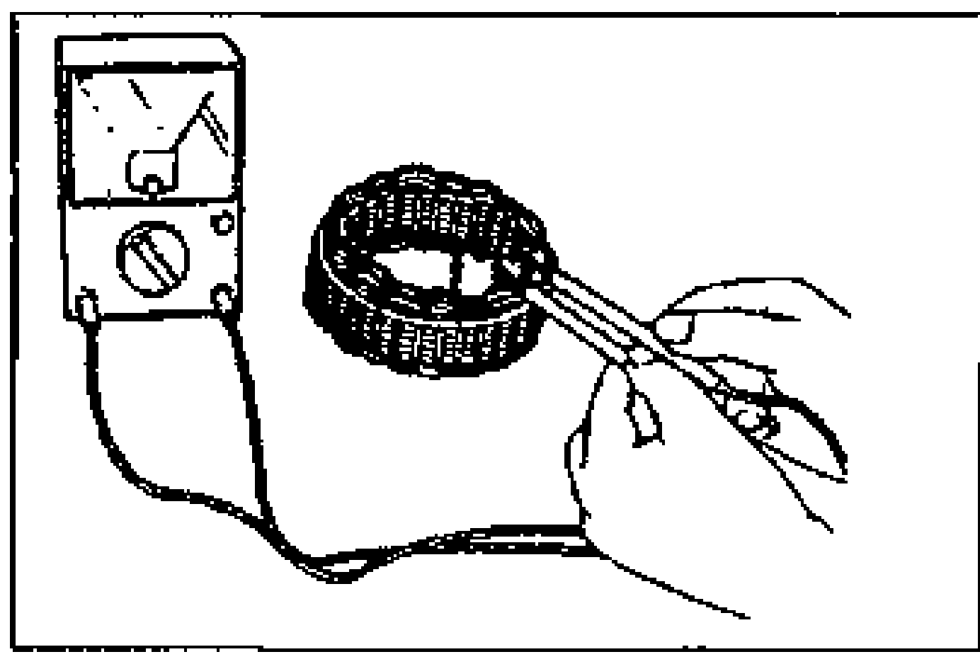 Ohmmeter probing between the stator coil leads to check continuity.