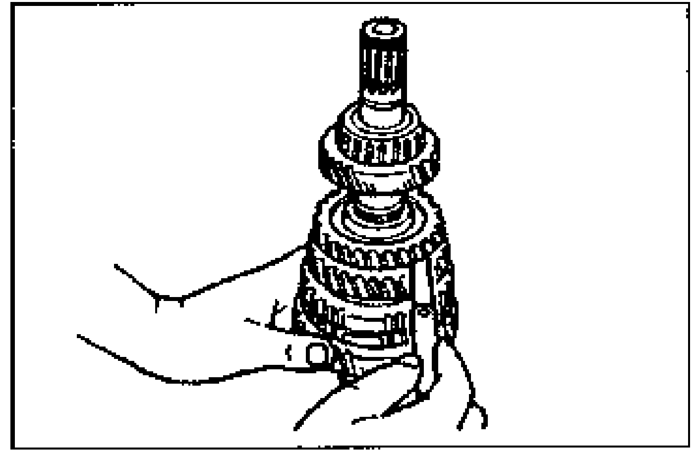 Hands holding the secondary shaft assembly while measuring the clearance between the 2nd gear and the secondary 3rd gear.