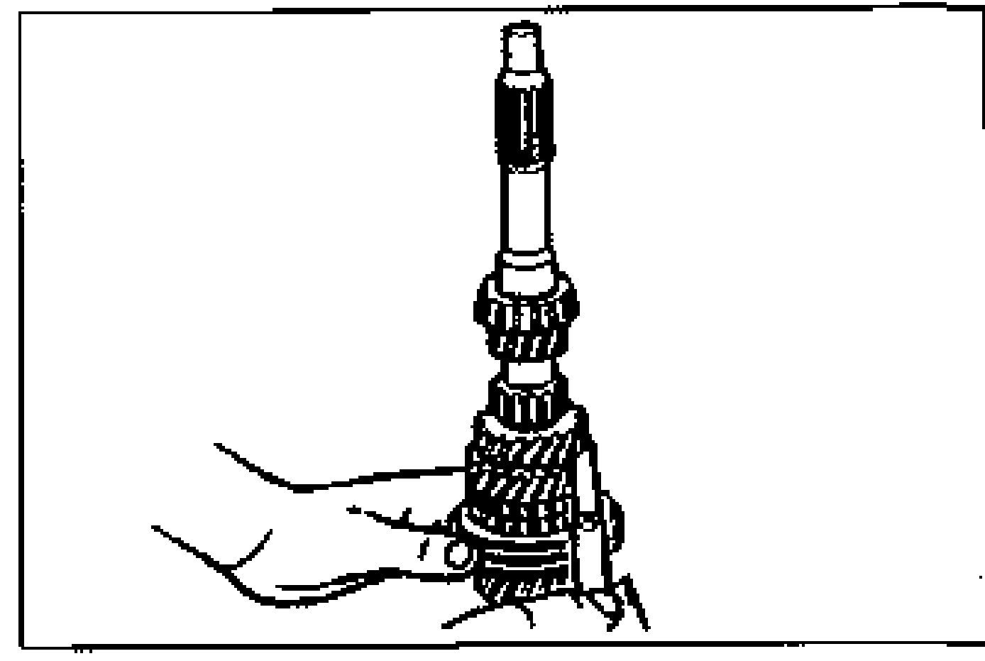 Hand holding the primary shaft assembly while measuring the clearance between the 3rd gear and 2nd gear.