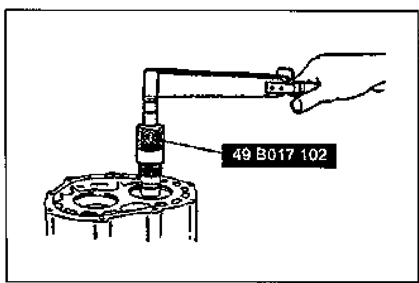 Connecting a torque wrench to the SST installed on the primary shaft gear assembly to measure the preload. Tool 49 B017 102 labeled.