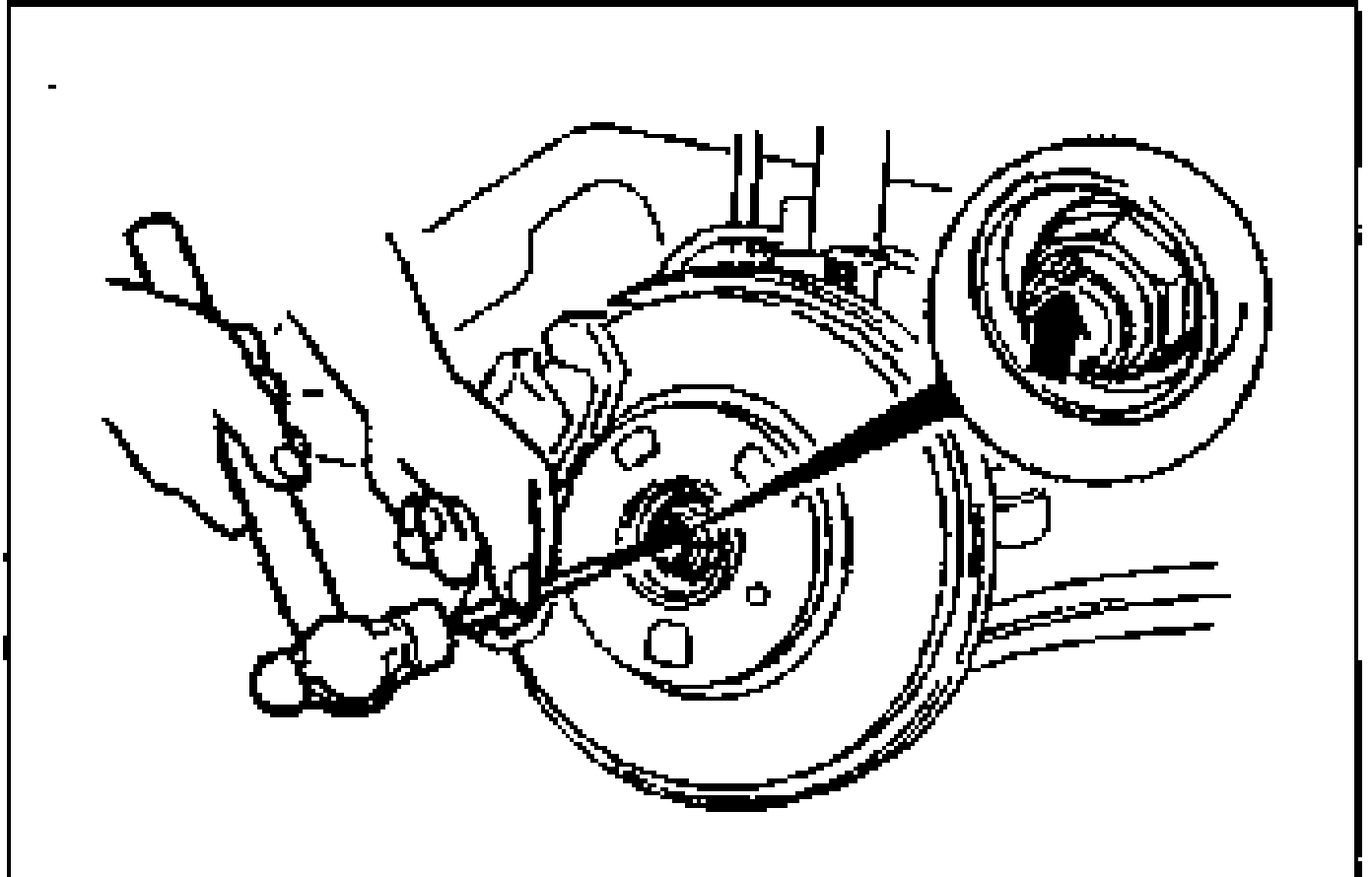 Removal Note — Locknut. A chisel and hammer are used to knock the crimped portion of the locknut outward on the wheel hub.