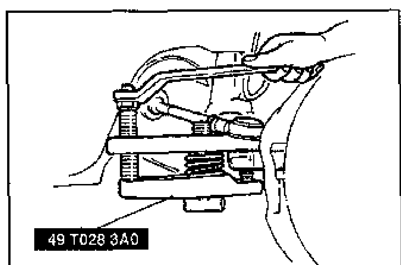 SST (tie-rod end puller, tool 49 T028 3A0) installed on the steering knuckle to disconnect the tie-rod end. A hand holds the wrench at top; the threaded SST clamps over the tie-rod end stud above the coil spring and lower arm.