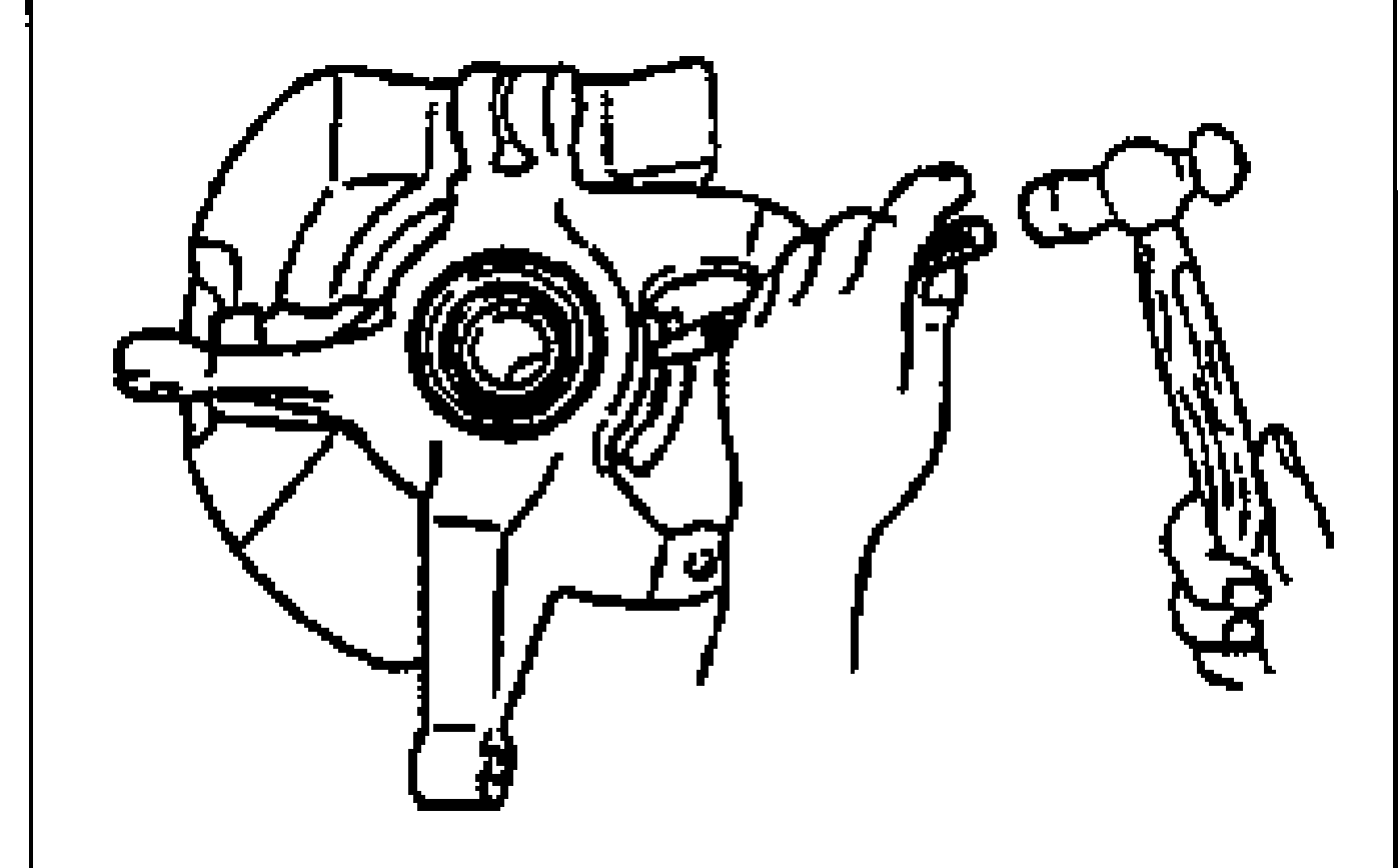 Hand using a chisel and hammer to remove the dust cover from the knuckle.
