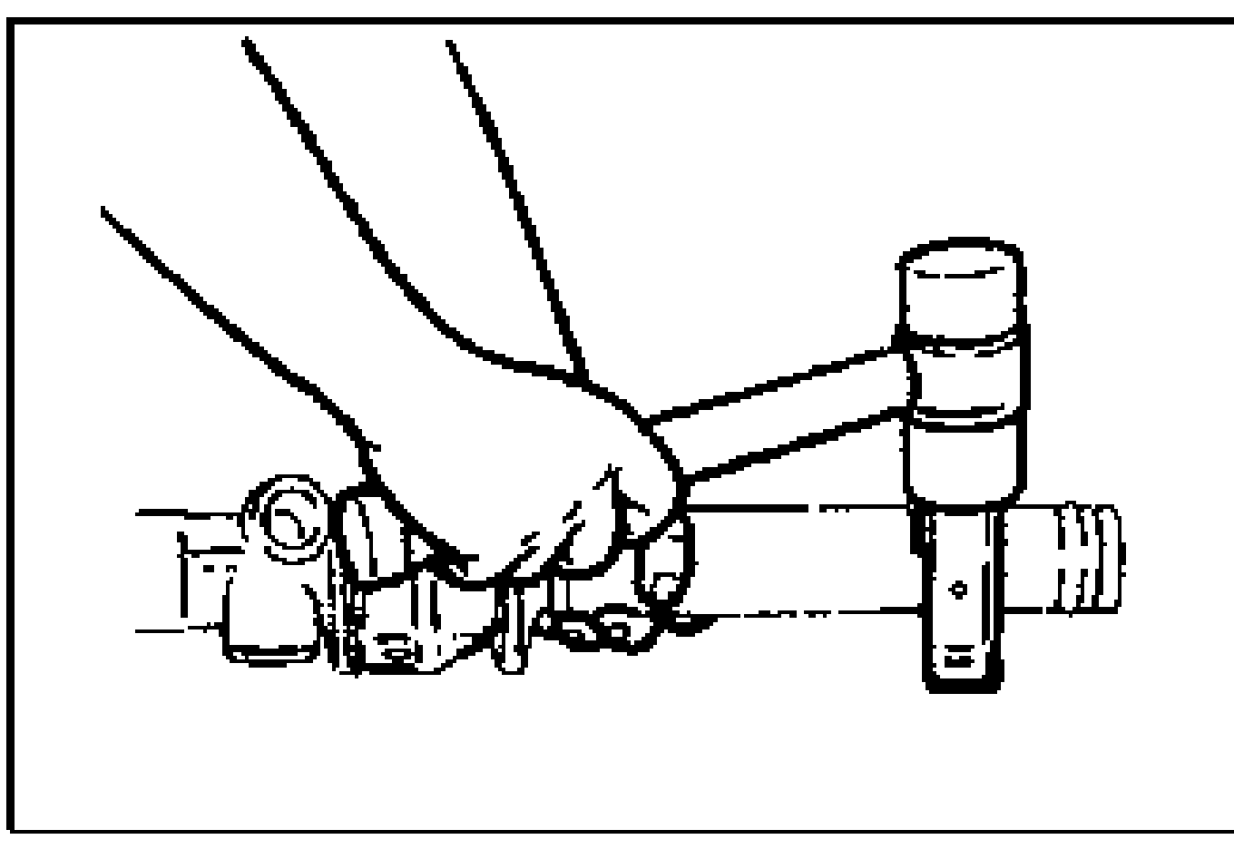Hand tapping a mounting bracket onto the mounting rubber with a plastic hammer.