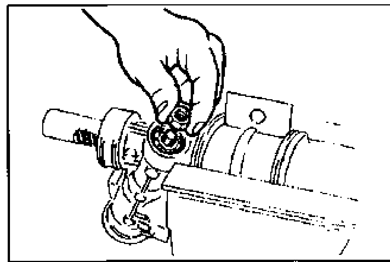Hand using a wrench to tighten the locknut on the pinion shaft after temporarily installing the tie rod on the tube side of the rack.