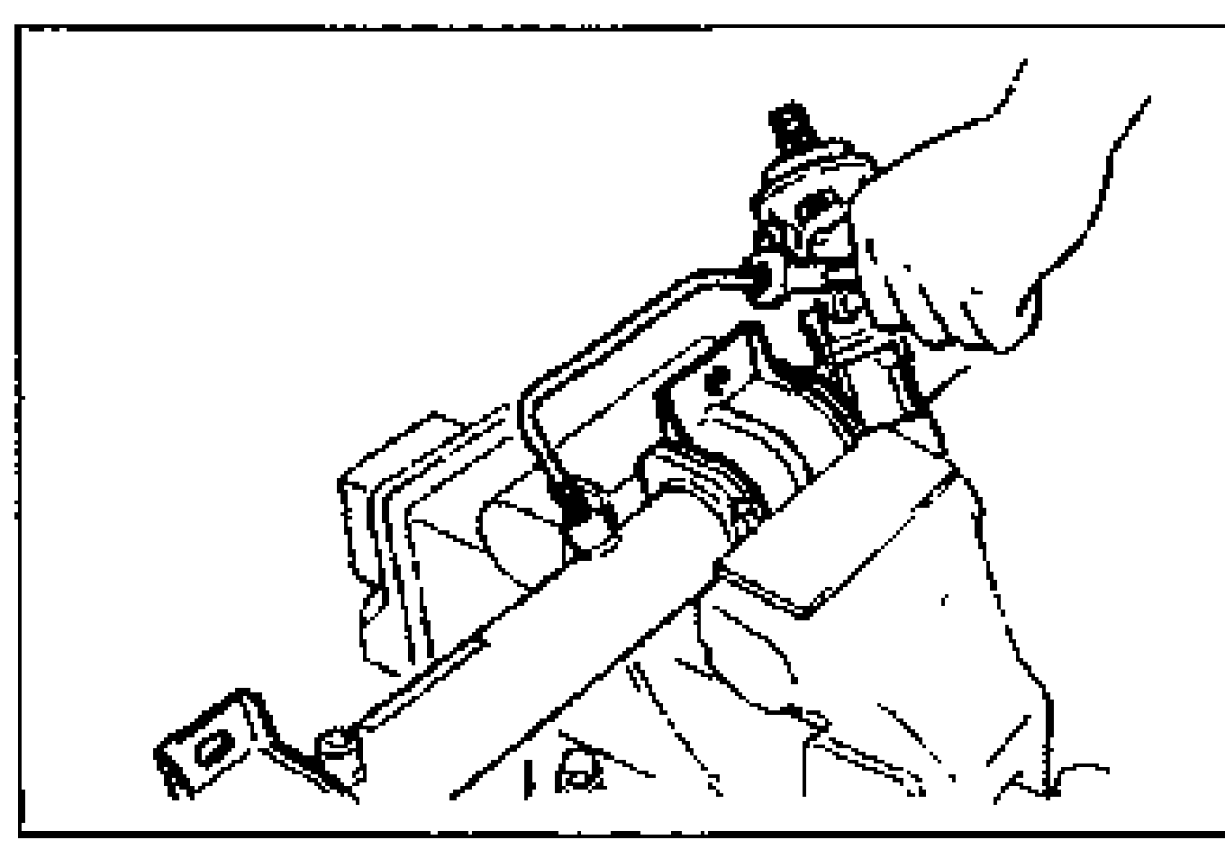 Mounting bracket secured in a vise with oil pipe connections facing upward; hand installing the oil pipes.