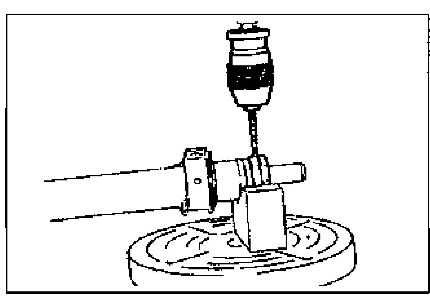 Using a drill to cut away the staked areas of the rack bushing before removal.