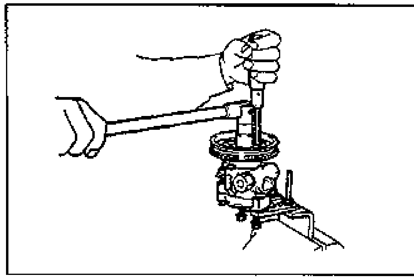 Removing the pulley locknut with a wrench while holding the pulley with a screwdriver inserted to prevent rotation.