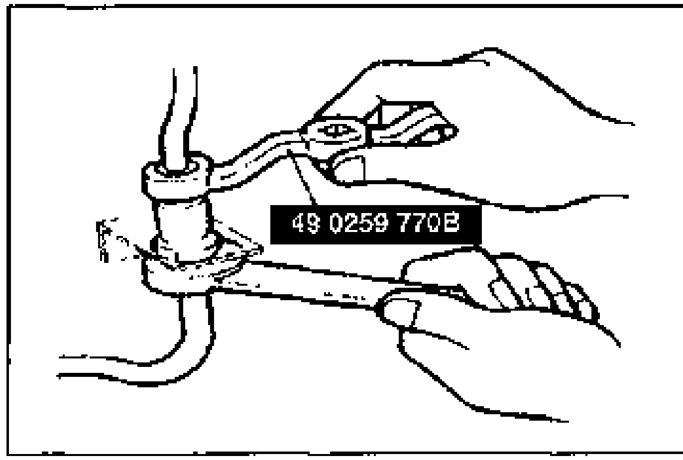 Hands using the SST flare-nut wrench (49 0259 770B) to remove the brake pipe at a flexible hose/bracket joint.