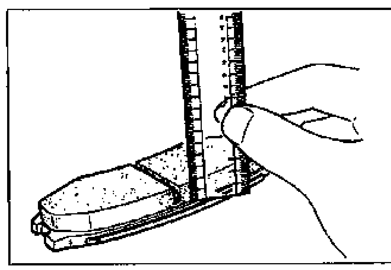 A hand using a scale/vernier to measure the remaining lining thickness of a disc pad assembly.