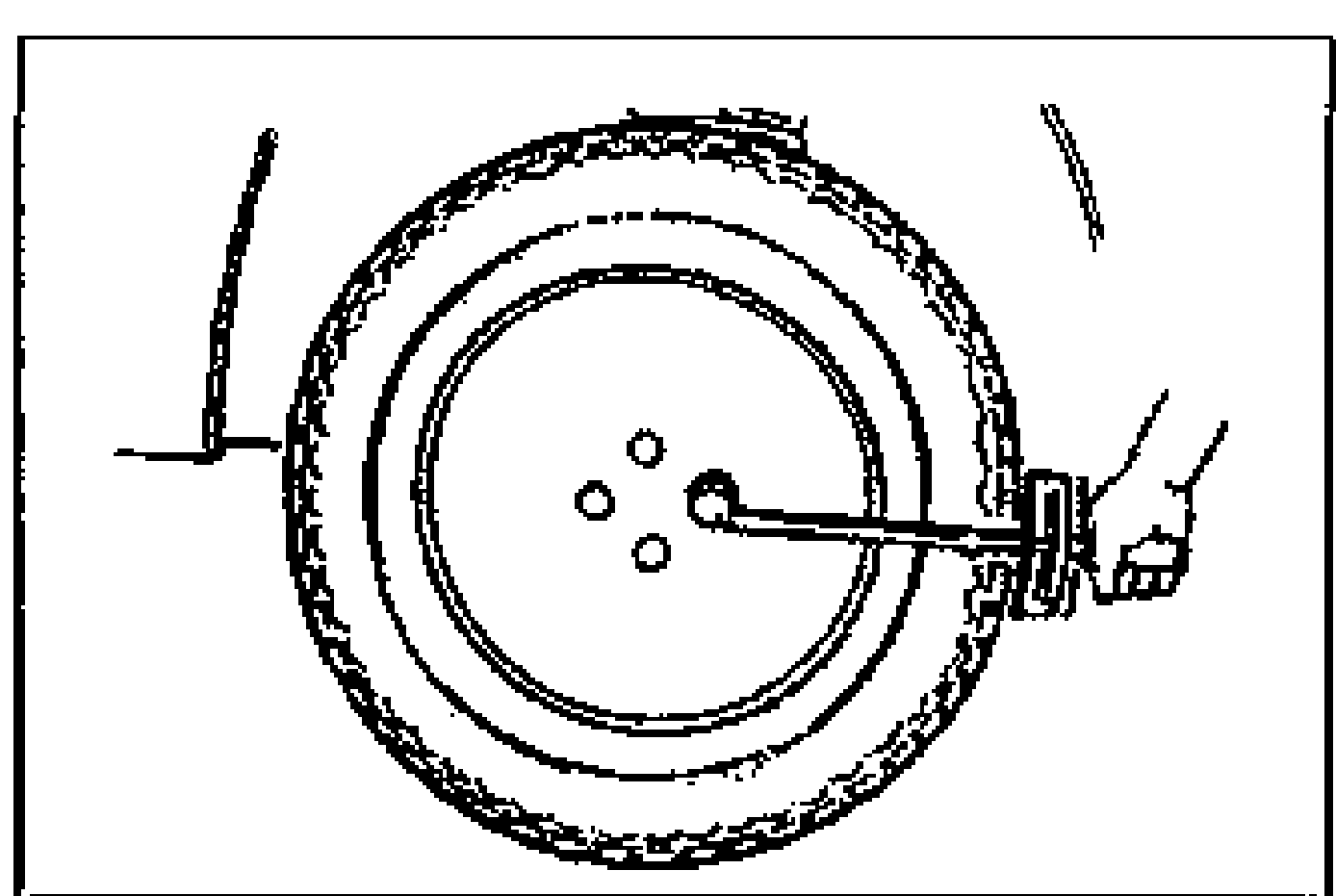 Illustration of a hand using a torque wrench on the wheel lug nuts during wheel installation, with the dial indicator probe contacting the lateral face of the wheel.