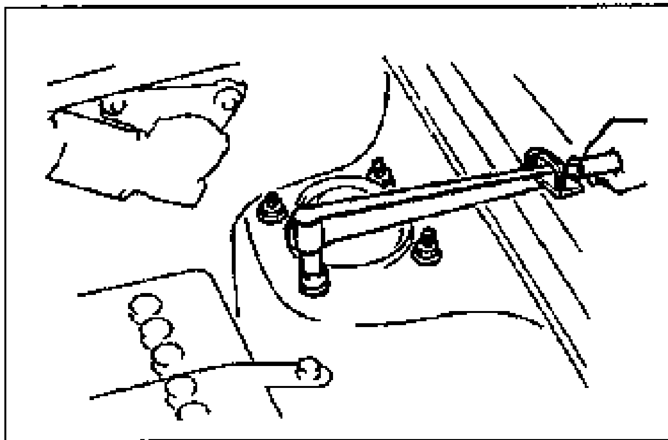 Engine-bay view of the strut mounting block with a wrench installing and tightening the mounting nuts.