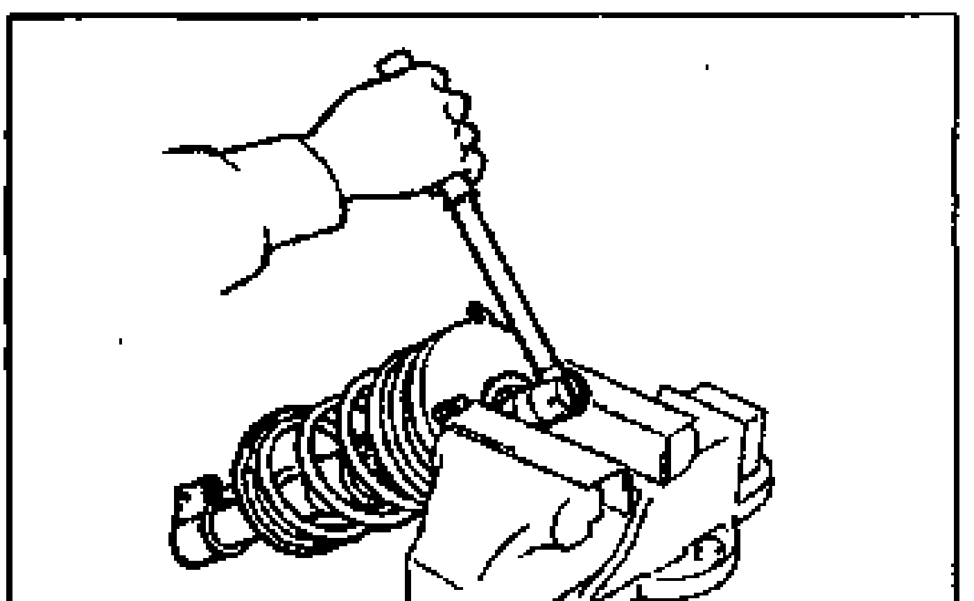 Disassembly Note illustration: a hand using a wrench to loosen the nut on a shock absorber/coil spring assembly secured (mounting block) in a bench vise.