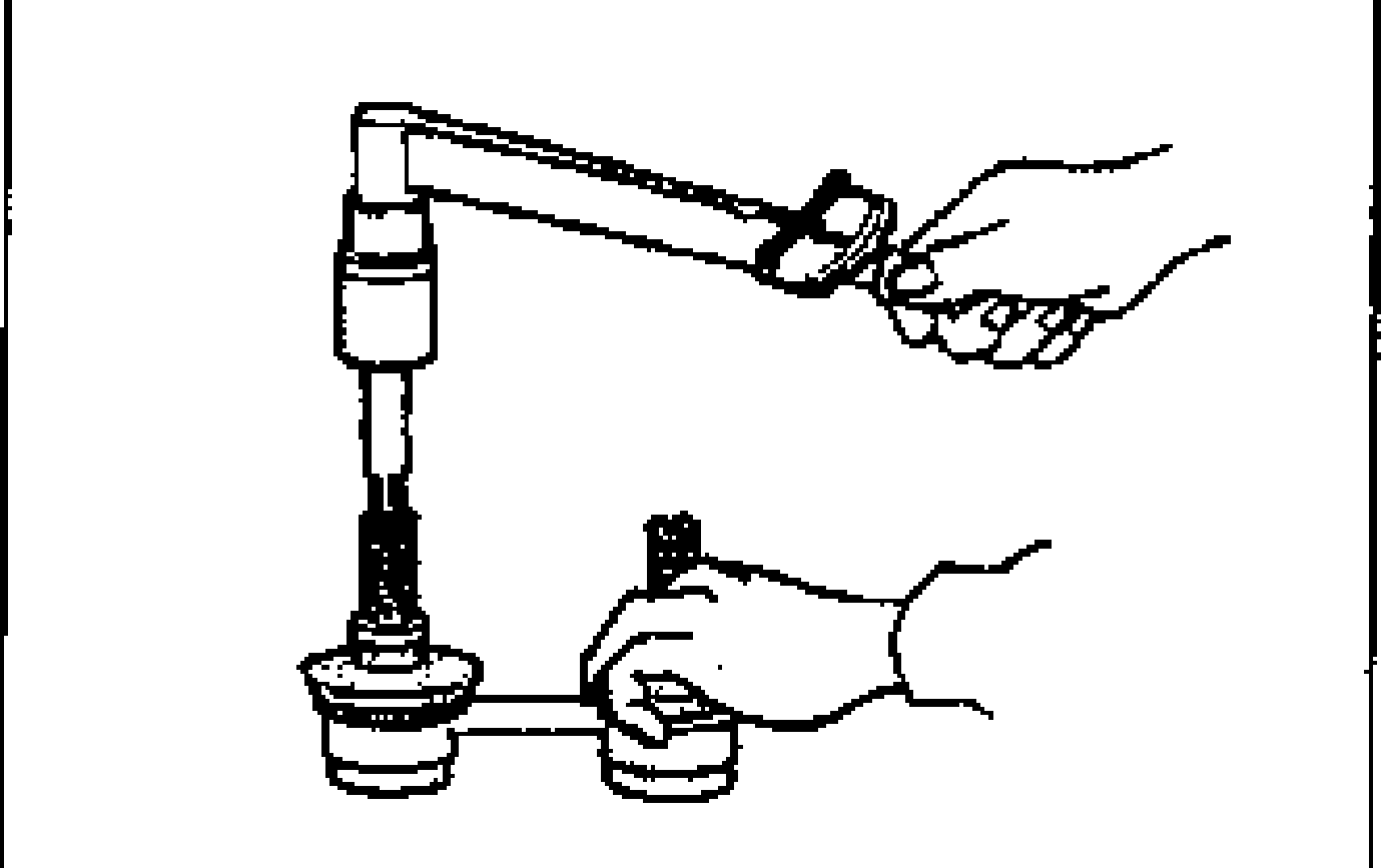 Stabilizer control link ball joint preload inspection: a hand measures the ball joint stud preload using a hexagon wrench fitted into the stud and a torque wrench.