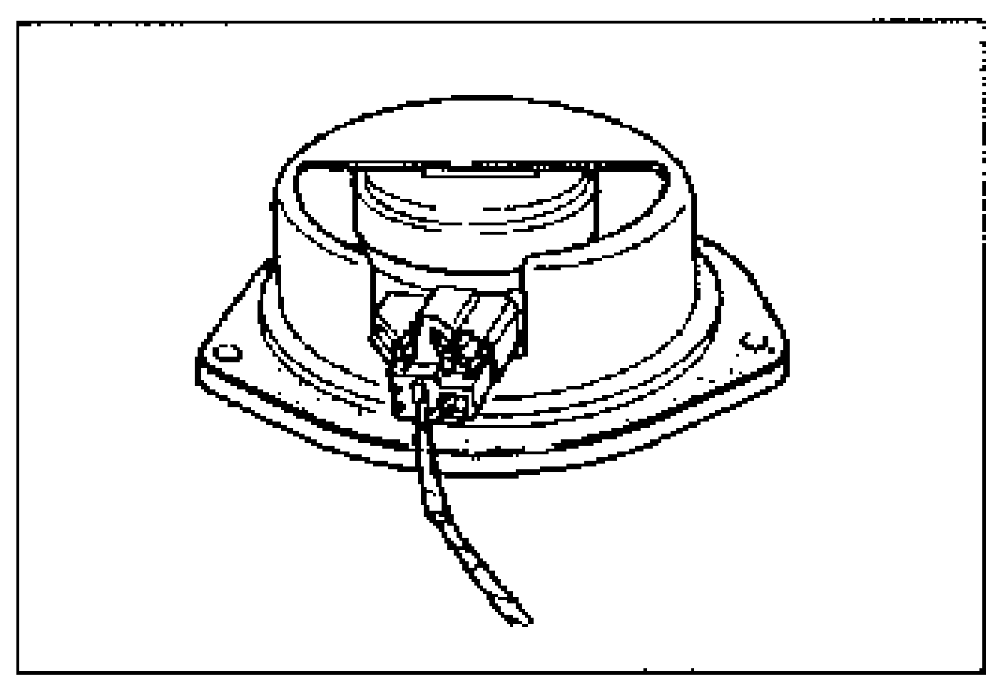 Photo of the door speaker removed from the door, showing the speaker connector at the base.