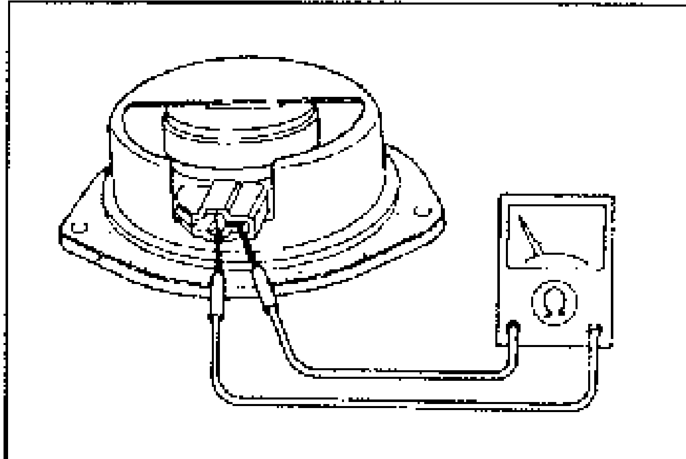 Photo of the rear speaker with an ohmmeter measuring resistance between the speaker terminals.
